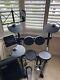 Yamaha Electronic Drum Kit With Rolled Headphones, Amplifier, And A Music Stand